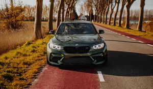 Preview wallpaper bmw, car, green, trees, road