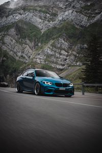 Preview wallpaper bmw, car, side view, road, rock