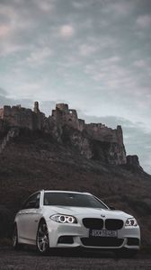 Preview wallpaper bmw, car, white, front view, rock, nature