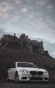 Preview wallpaper bmw, car, white, front view, rock, nature