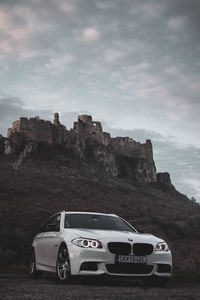 Preview wallpaper bmw, car, white, front view, rock, nature