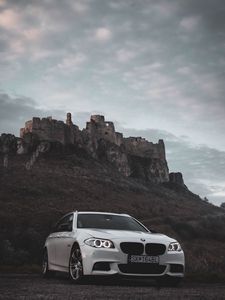 Preview wallpaper bmw, car, white, front view, rock, nature