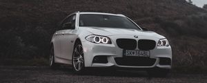 Preview wallpaper bmw, car, white, front view, rock, nature