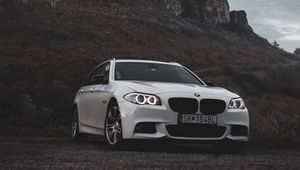 Preview wallpaper bmw, car, white, front view, rock, nature