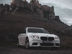 Preview wallpaper bmw, car, white, front view, rock, nature