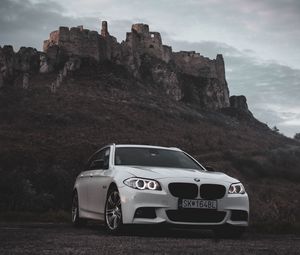 Preview wallpaper bmw, car, white, front view, rock, nature