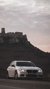 Preview wallpaper bmw, car, white, road, castle, ruins