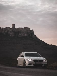 Preview wallpaper bmw, car, white, road, castle, ruins