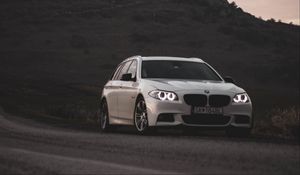 Preview wallpaper bmw, car, white, road, castle, ruins