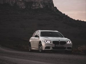 Preview wallpaper bmw, car, white, road, castle, ruins