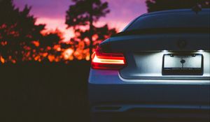 Preview wallpaper bmw, rear view, headlight, sunset, light