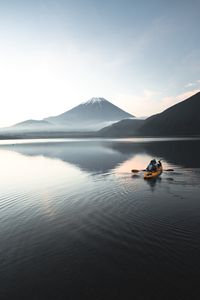 Preview wallpaper boat, canoe, volcano, sea, ripples