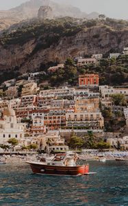 Preview wallpaper boat, city, buildings, coast, rocks, sea