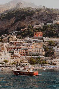 Preview wallpaper boat, city, buildings, coast, rocks, sea