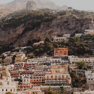 Preview wallpaper boat, city, buildings, coast, rocks, sea