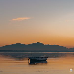 Preview wallpaper boat, lake, sunset, dusk, water
