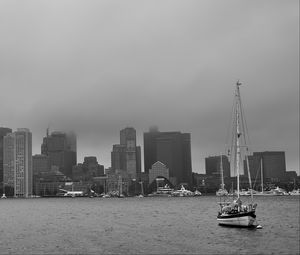 Preview wallpaper boat, mast, sea, buildings, city, black and white