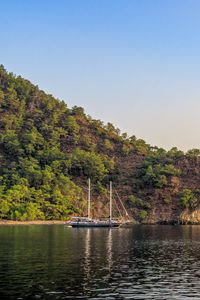 Preview wallpaper boat, masts, lake, hill, trees