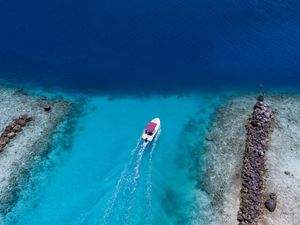 Preview wallpaper boat, ocean, stones, aerial view