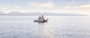 Preview wallpaper boat, people, sea, waves, mountains, sky