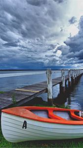 Preview wallpaper boat, pier, coast, reservoir, cloudy, evening
