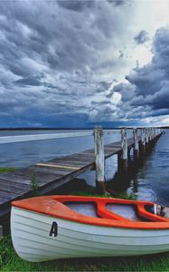 Preview wallpaper boat, pier, coast, reservoir, cloudy, evening