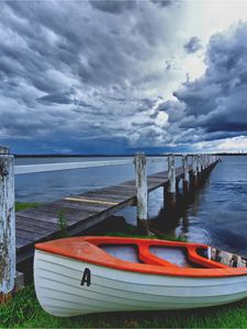 Preview wallpaper boat, pier, coast, reservoir, cloudy, evening