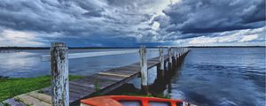 Preview wallpaper boat, pier, coast, reservoir, cloudy, evening