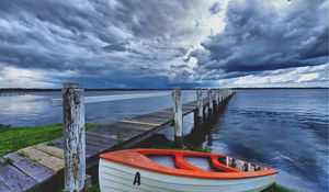 Preview wallpaper boat, pier, coast, reservoir, cloudy, evening