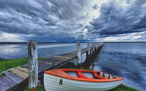 Preview wallpaper boat, pier, coast, reservoir, cloudy, evening