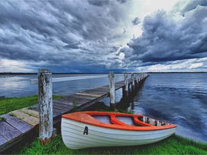 Preview wallpaper boat, pier, coast, reservoir, cloudy, evening