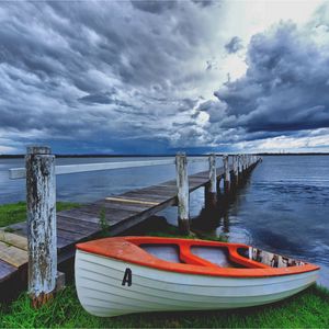 Preview wallpaper boat, pier, coast, reservoir, cloudy, evening