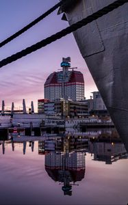 Preview wallpaper boat, pier, water, reflection, city, buildings, twilight