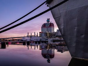 Preview wallpaper boat, pier, water, reflection, city, buildings, twilight