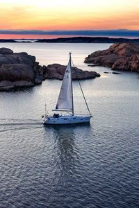 Preview wallpaper boat, sail, sea, stones, sunset, horizon