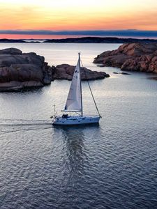 Preview wallpaper boat, sail, sea, stones, sunset, horizon