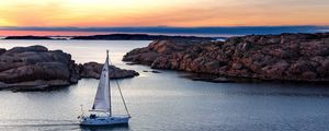 Preview wallpaper boat, sail, sea, stones, sunset, horizon