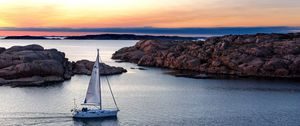 Preview wallpaper boat, sail, sea, stones, sunset, horizon