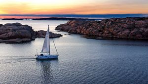 Preview wallpaper boat, sail, sea, stones, sunset, horizon