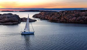 Preview wallpaper boat, sail, sea, stones, sunset, horizon