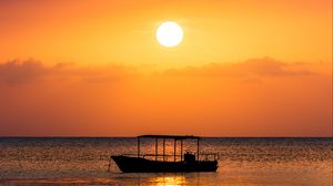 Preview wallpaper boat, sea, sunset, sun, water, dusk