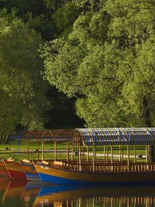 Preview wallpaper boats, coast, canopy, lake, slovenia, trees