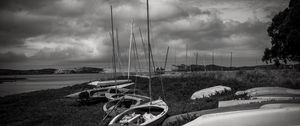 Preview wallpaper boats, grass, sea, clouds, black and white