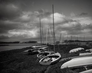 Preview wallpaper boats, grass, sea, clouds, black and white