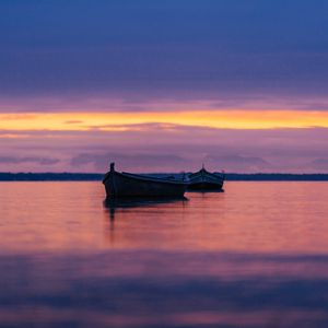 Preview wallpaper boats, lake, horizon, sunset, dark