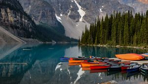 Preview wallpaper boats, lake, stones, mountains, snowy