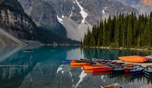 Preview wallpaper boats, lake, stones, mountains, snowy