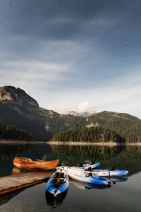 Preview wallpaper boats, mountains, lake, pier, starry sky, stars