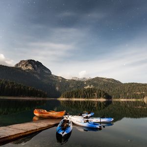 Preview wallpaper boats, mountains, lake, pier, starry sky, stars
