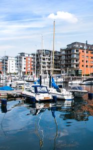 Preview wallpaper boats, pier, city, buildings, water